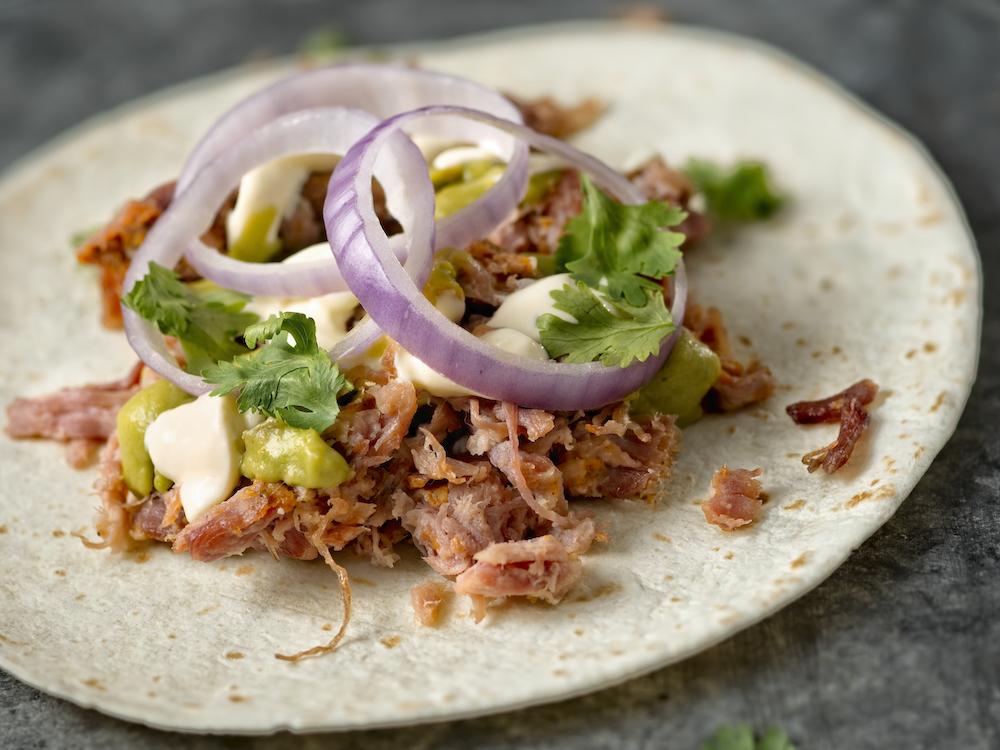 Close up of rustic mexican american pulled pork tacos