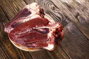 Beef heart on a wooden rustic table.