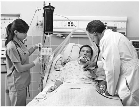 young man in hospital bed respirator doctor and nurse at bedside