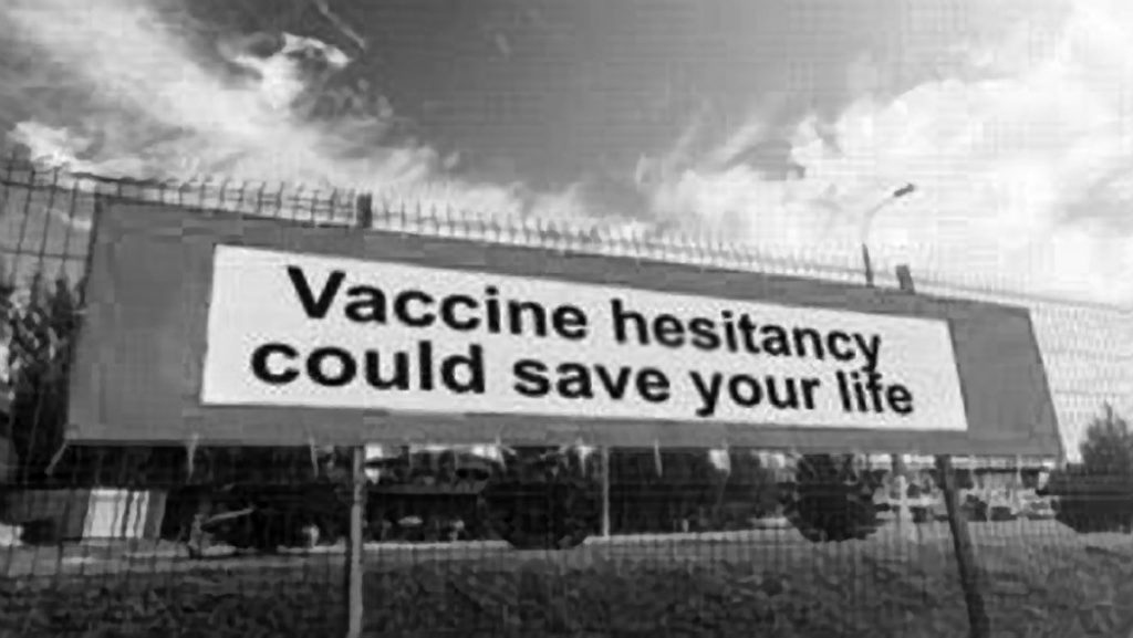 sign on fence reads Vaccine hesitancy could save your life